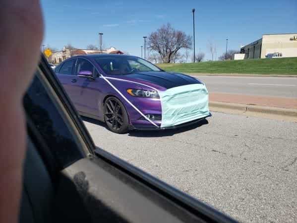 car with mask on hood