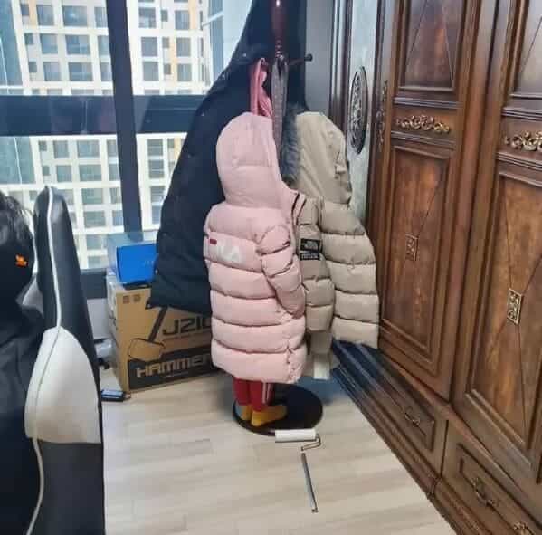 accidental camouflage kid hiding in coat rack