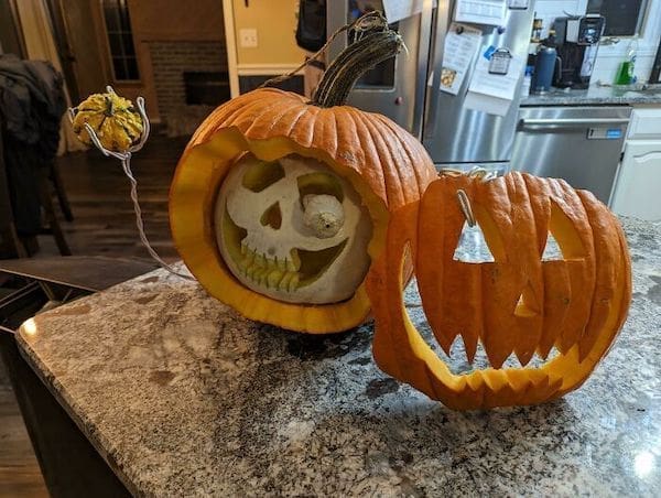 face of pumpkin removed with skull below