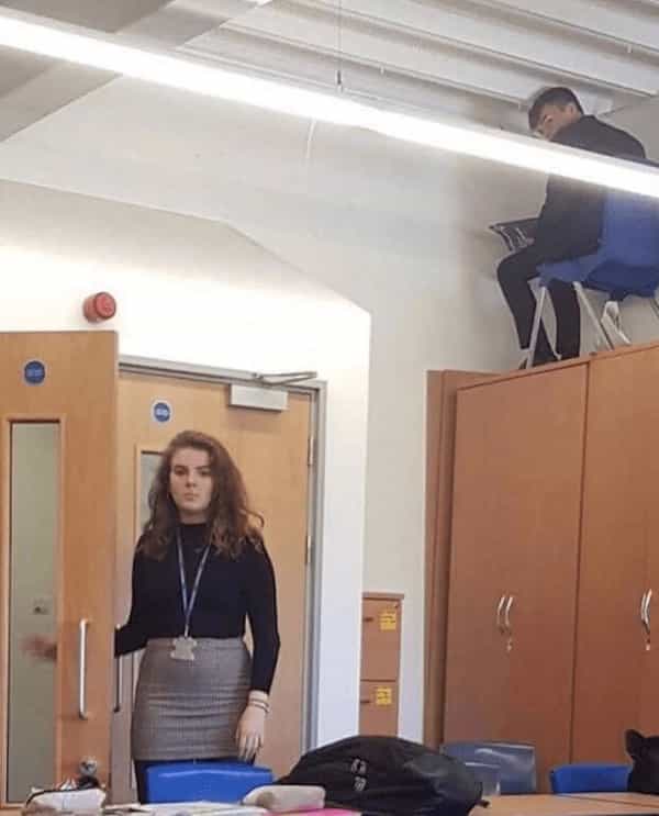 cursed images kid in desk on cupboard