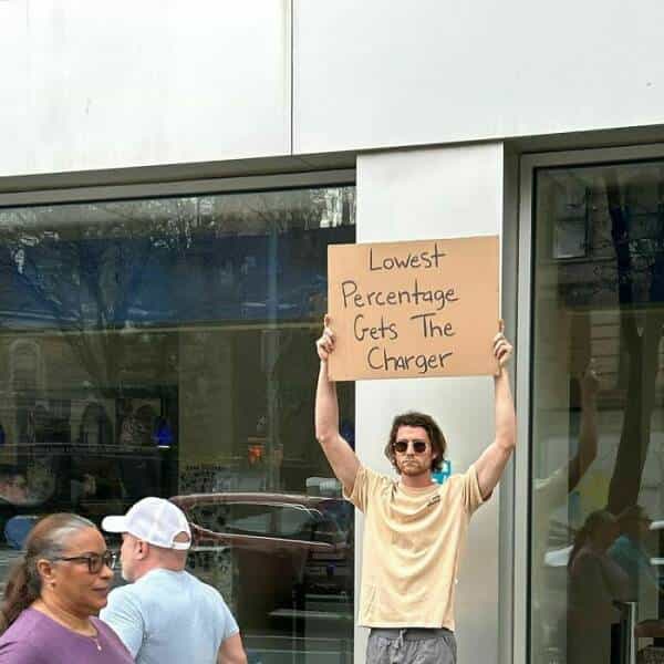 dude with a sign Lowest Percentage Gets The Charger