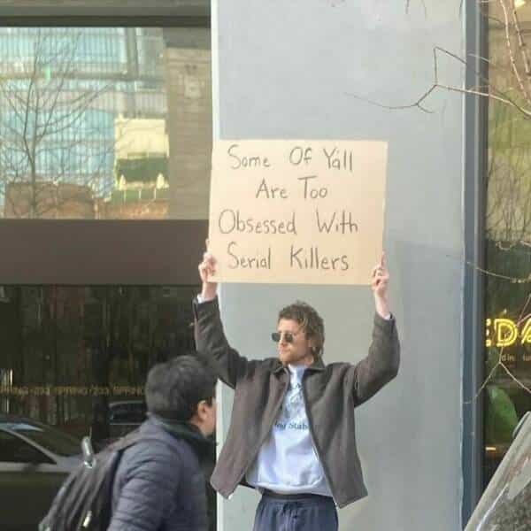 dude with a sign Some Of Vall Are Too Obsessed With Serial Killers