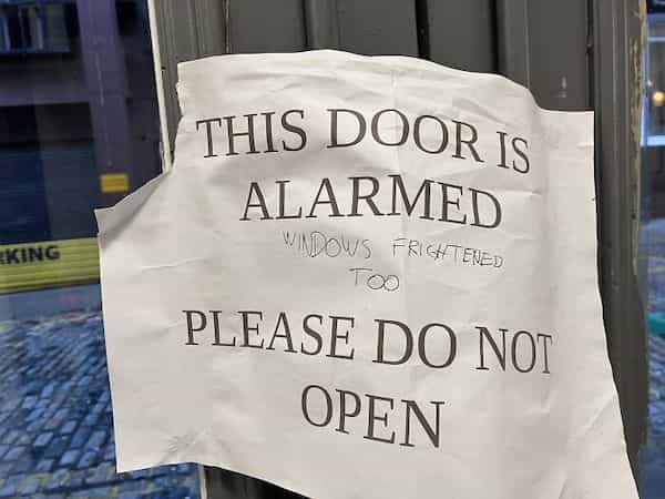 funny graffiti THIS DOOR Is ALARMED WINDOWS FRIGHTENED TOO PLEASE DO NOI OPEN