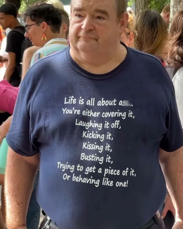 cursed t-shirts Life is all about as You're either covering it, Laughing it off, Kicking it, Kissing it, Busting it, Trying to get a piece of it, Or behaving like one!