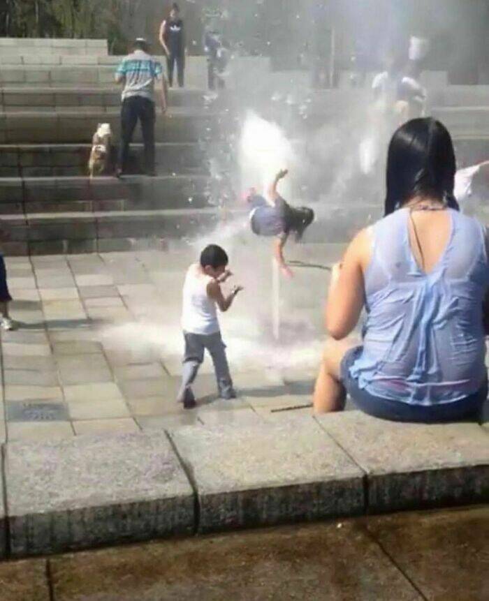 funny pics girl tossed up by water fountain