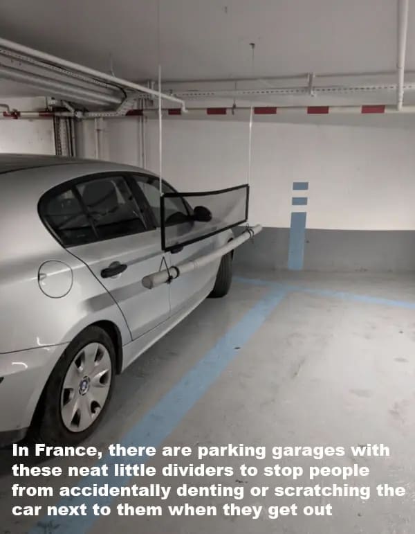 In France, there are parking garages with these neat little dividers to stop people from accidentally denting or scratching the car next to them when they get out