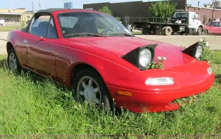 funny miata, miatas with threatening auras, comedic roadster bits, small convertible jokes, quirky sports car humor, Miata memes, comedic two-seater illusions, beloved tiny ride references, Mazda jokes, brand-based comedic angles, automaker witty bits, car humor, vehicular comedic lines, automotive meltdown commentary