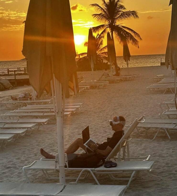 guy playing VR on the beach