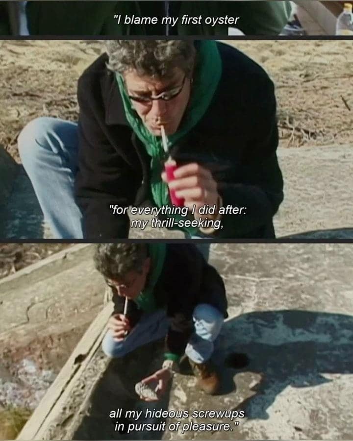 Anthony Bourdain lighting a cigarette while eating oysters outdoors