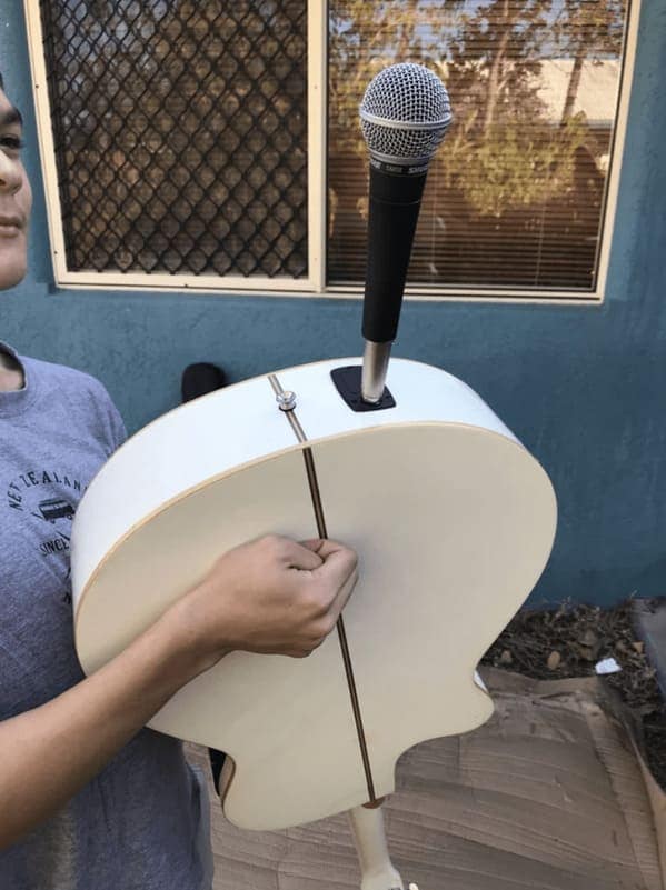 cursed instruments, instruments with threatening auras, weird instruments, instrument fails, bizarre music, odd instruments, performance art, music gadgets, funny instrument photos, experimental music, custom instruments, music humor, instrument design, odd musical gear, creepy instruments