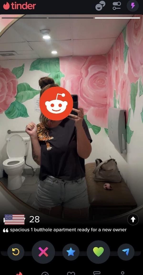 Woman poses in floral restroom mirror with bizarre bio about butthole apartment