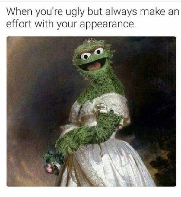 Oscar the Grouch dressed as a Victorian lady in a white gown holding flowers.