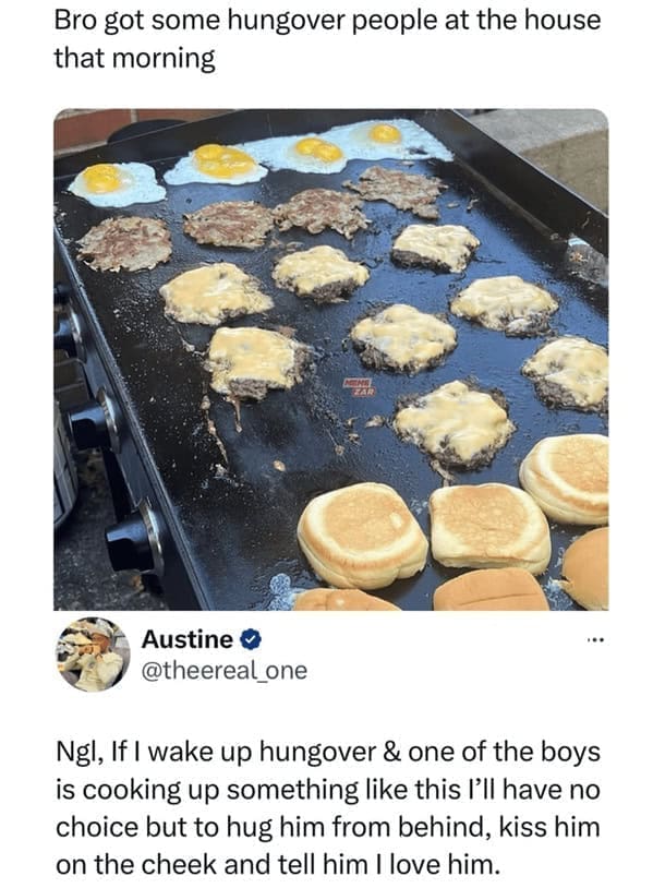 Griddle covered with fried eggs and cheeseburgers being cooked.