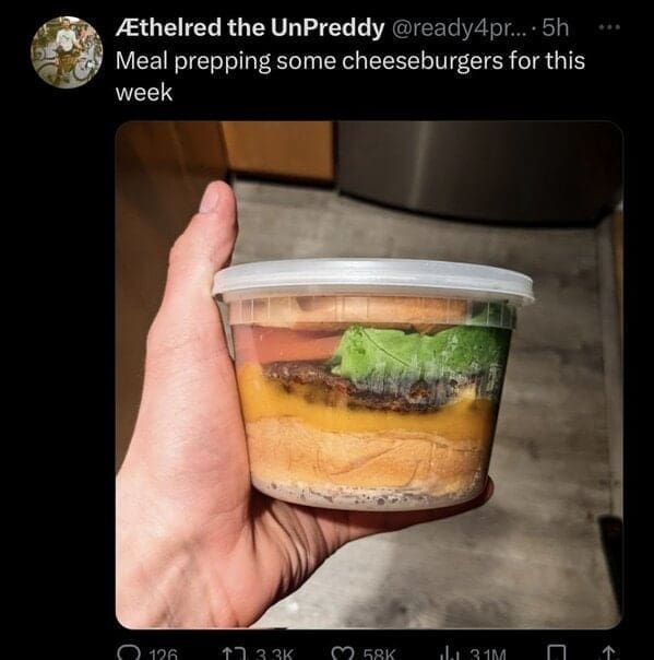 Cheeseburger packed whole in a clear plastic meal prep container.