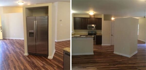A kitchen with a massive wall awkwardly blocking the fridge from open access