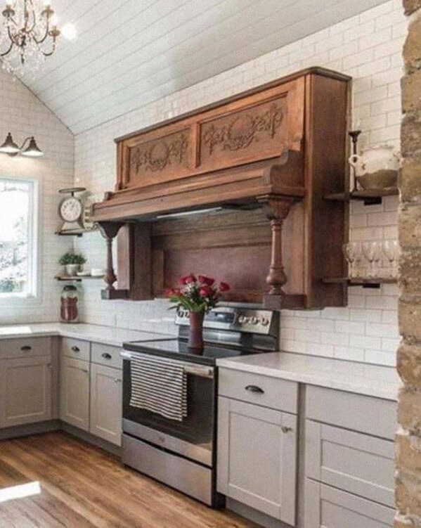 An antique upright piano awkwardly repurposed as a stove range hood in a kitchen