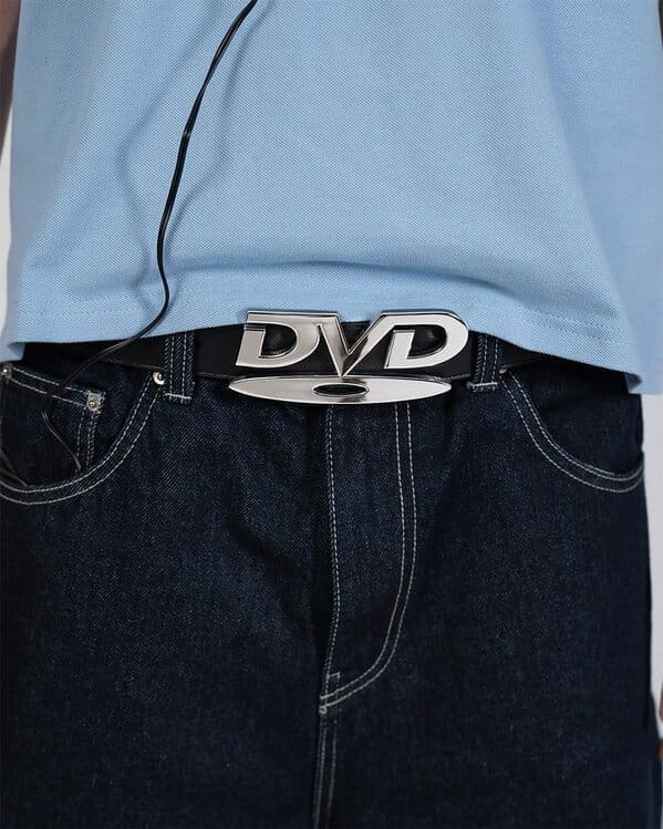 Person wearing a belt with a DVD logo buckle