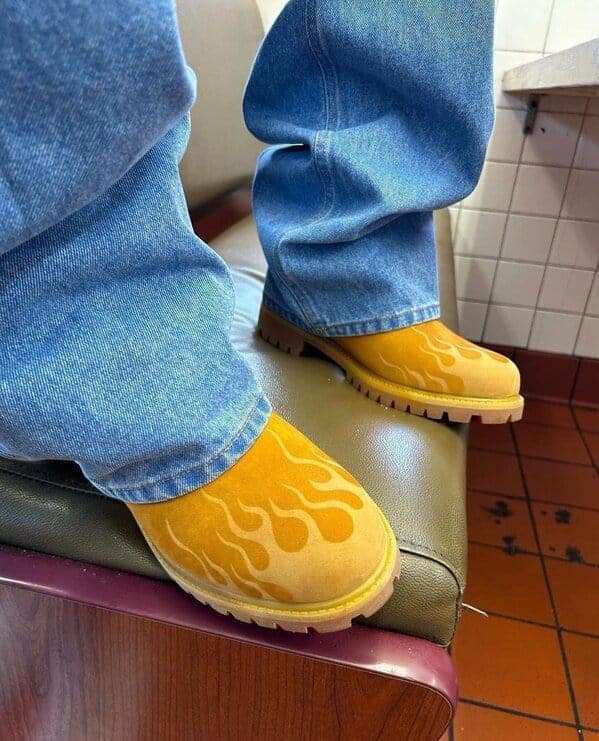 Yellow boots with flame design and baggy jeans