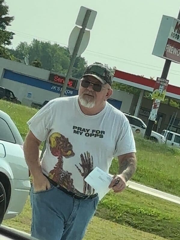 Man wearing “Pray for my opps” skeleton T-shirt