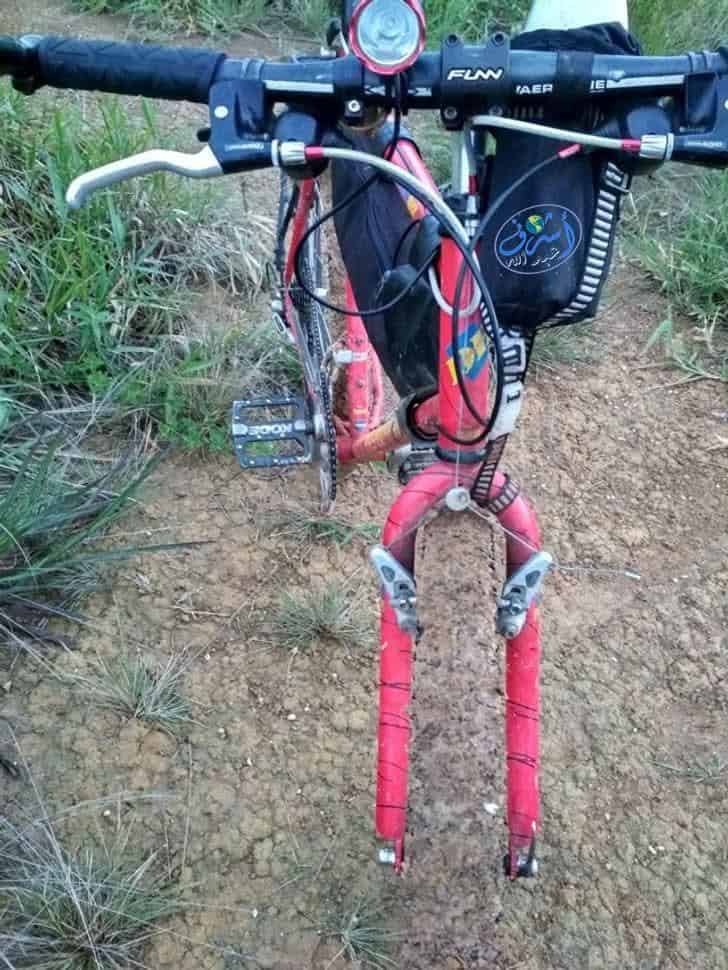 funny optical illusions photo of a bicycle with a nearly invisible front tire blending perfectly into the dirt path