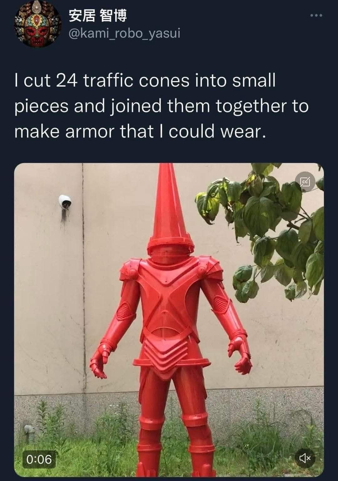 Person wearing creative armor made from 24 red traffic cones.