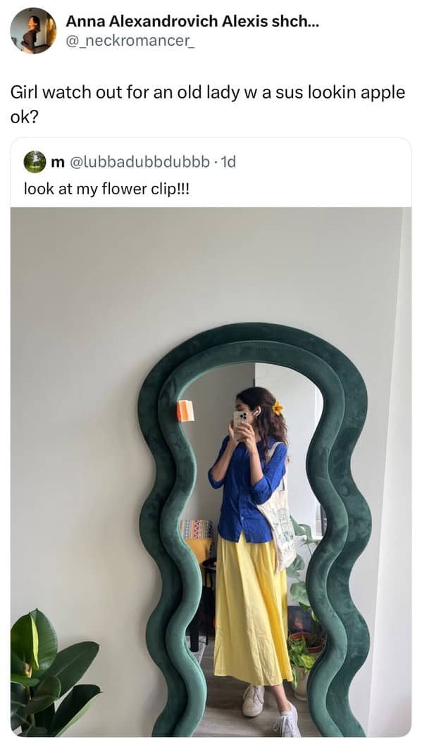 Girl in front of wavy mirror showing off yellow flower hair clip