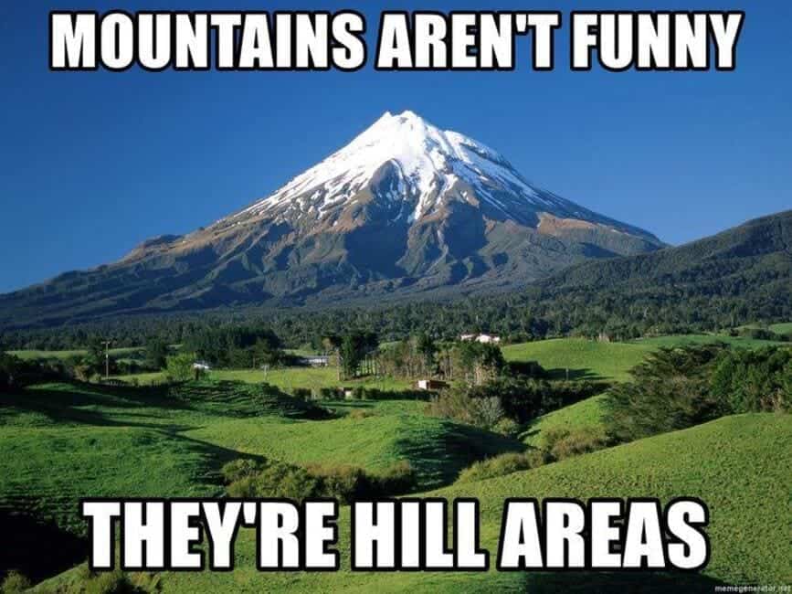 Mountain landscape with text overlay, "Mountains aren't funny, they're hill areas," a classic geography pun meme.