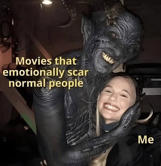 Demon hugs smiling girl meme captioned “Movies that emotionally scar normal people” and “Me”