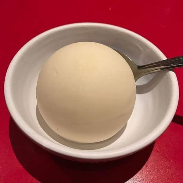 Perfectly spherical white dessert in a small bowl