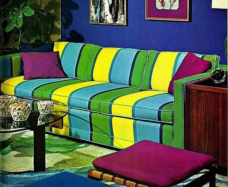 Retro striped sofa in blue, green, and yellow with bold wall art