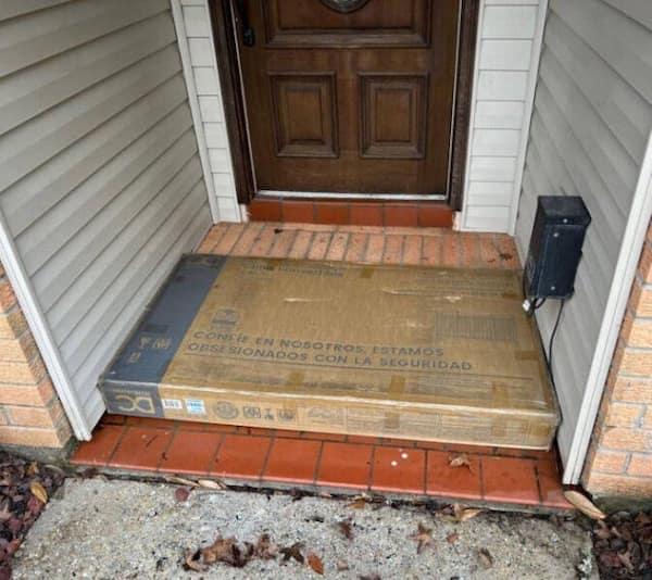 Satisfying photo of a large TV box fitting exactly into a tiny alcove by the front door, demonstrating the pleasing effect of a perfect fit.