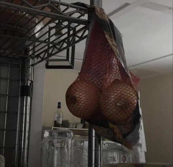 Onions in a net bag resembling a funny shape.