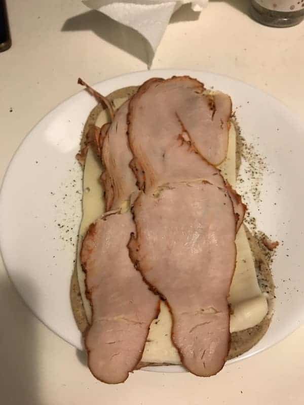 Sliced deli meat shaped like a person on bread.