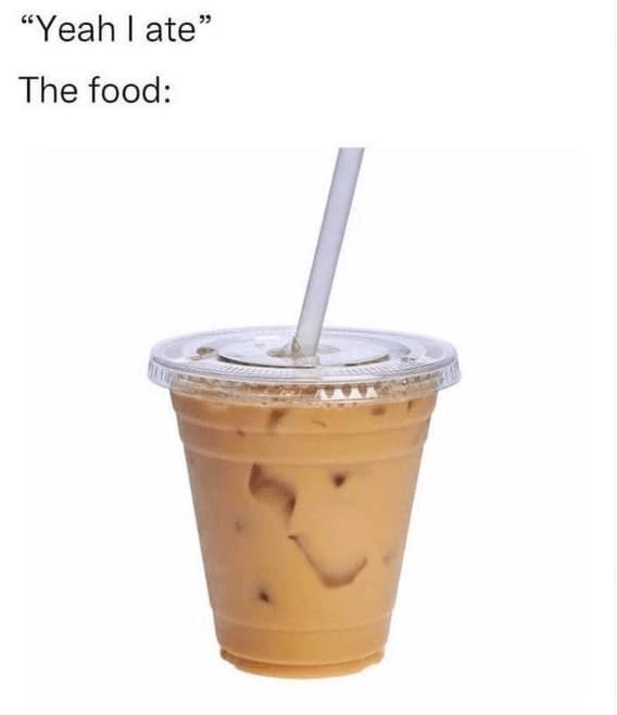Iced coffee in clear plastic cup with straw, white background.