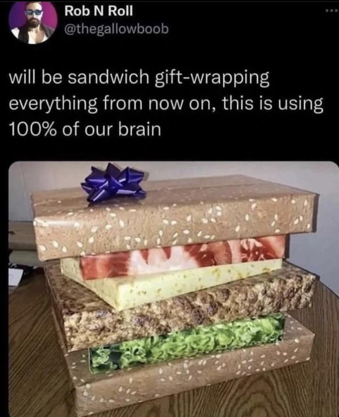 Stack of gift boxes wrapped to look like a giant sandwich with bow on top.