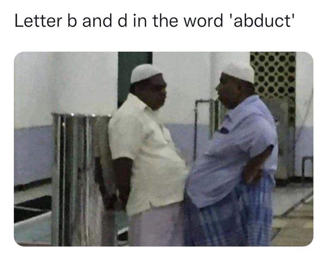 Two men in traditional attire stand belly-to-belly with the caption “Letter b and d in the word ‘abduct’.”