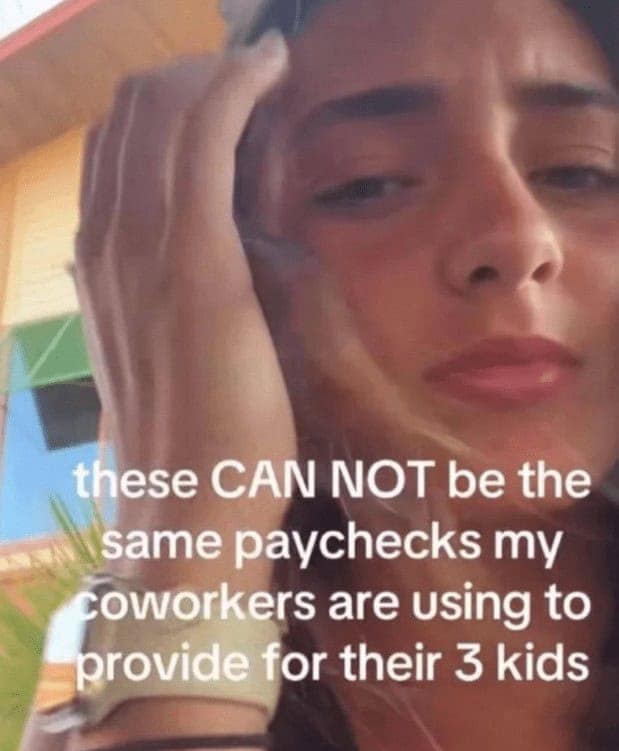 A woman looking confused about how her coworkers can afford families on the same paycheck.