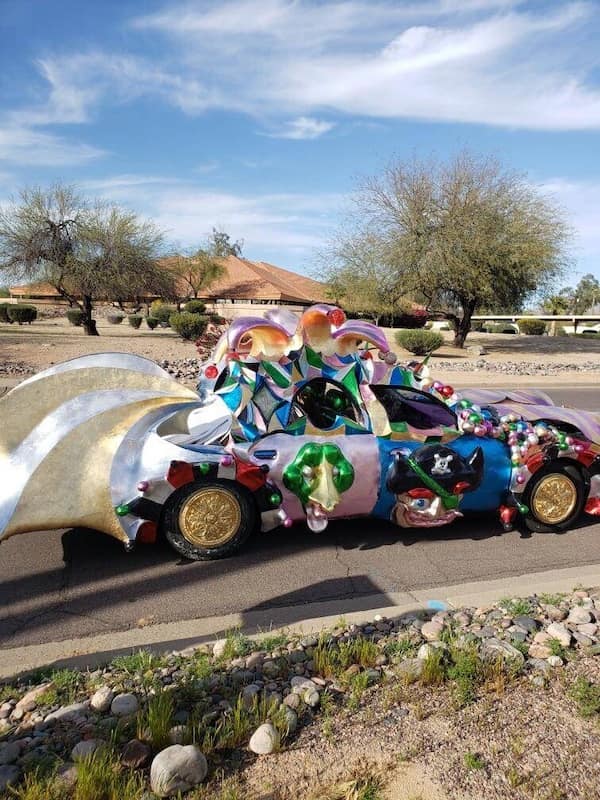 cursed cars decorated in colorful 3D sculptures and gold wheels