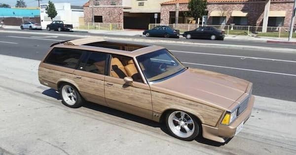 cursed cars with beige wood panel wagon body kit
