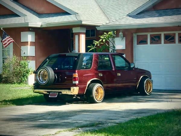 cursed cars SUV with extreme wide gold wheels