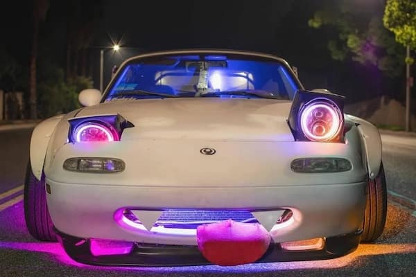 cursed cars with cartoon face headlights and tongue bumper