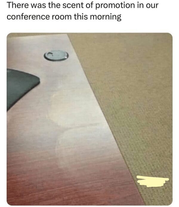 Conference table with faint cheek-shaped marks—caption about “the scent of promotion.”
