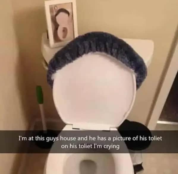 Bathroom with framed photo of the same toilet on display