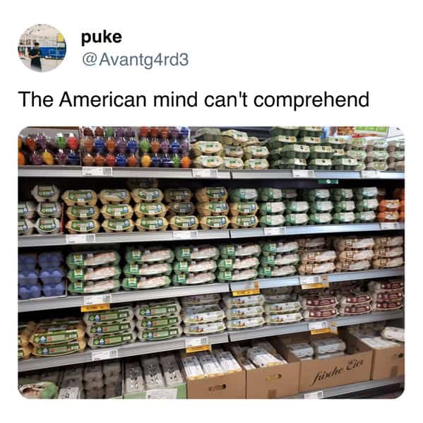 Grocery store shelf stocked with colorful eggs, not refrigerated.
