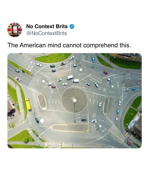 A complex multi-circle roundabout viewed from above with many cars