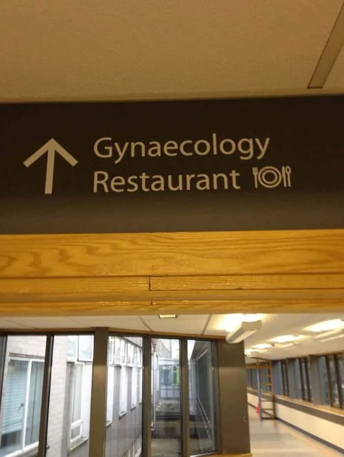 A hospital sign directing people to both the Gynaecology department and the restaurant.