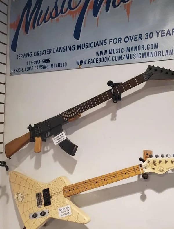 Funny meme of an electric guitar hanging on a wall that looks like an AK-47.
