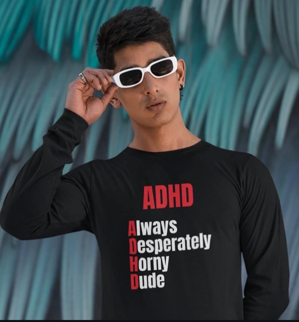 Guy wearing a shirt that redefines ADHD as “Always Desperately Horny Dude”