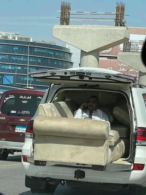 Man using SUV trunk as living room with sofa