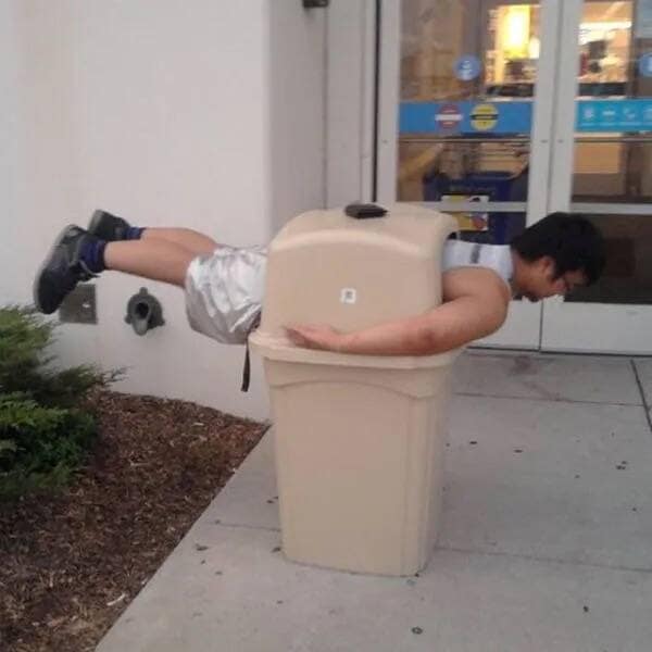 A funny meme of a man doing the "planking" trend in a public trash can.